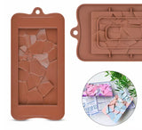 A brown silicone mould with a cracked design for making chocolate bars, with an inset image showing the mould being used to shape chocolate.